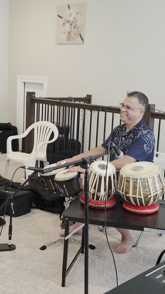 Percussionist smiling behind the tabla