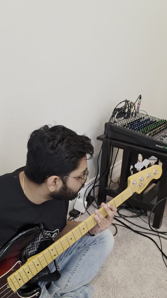 Bassist playing beside the mixer
