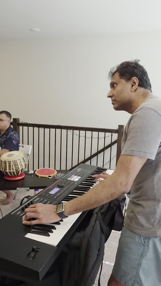 Keyboard player at the synth with tabla behind